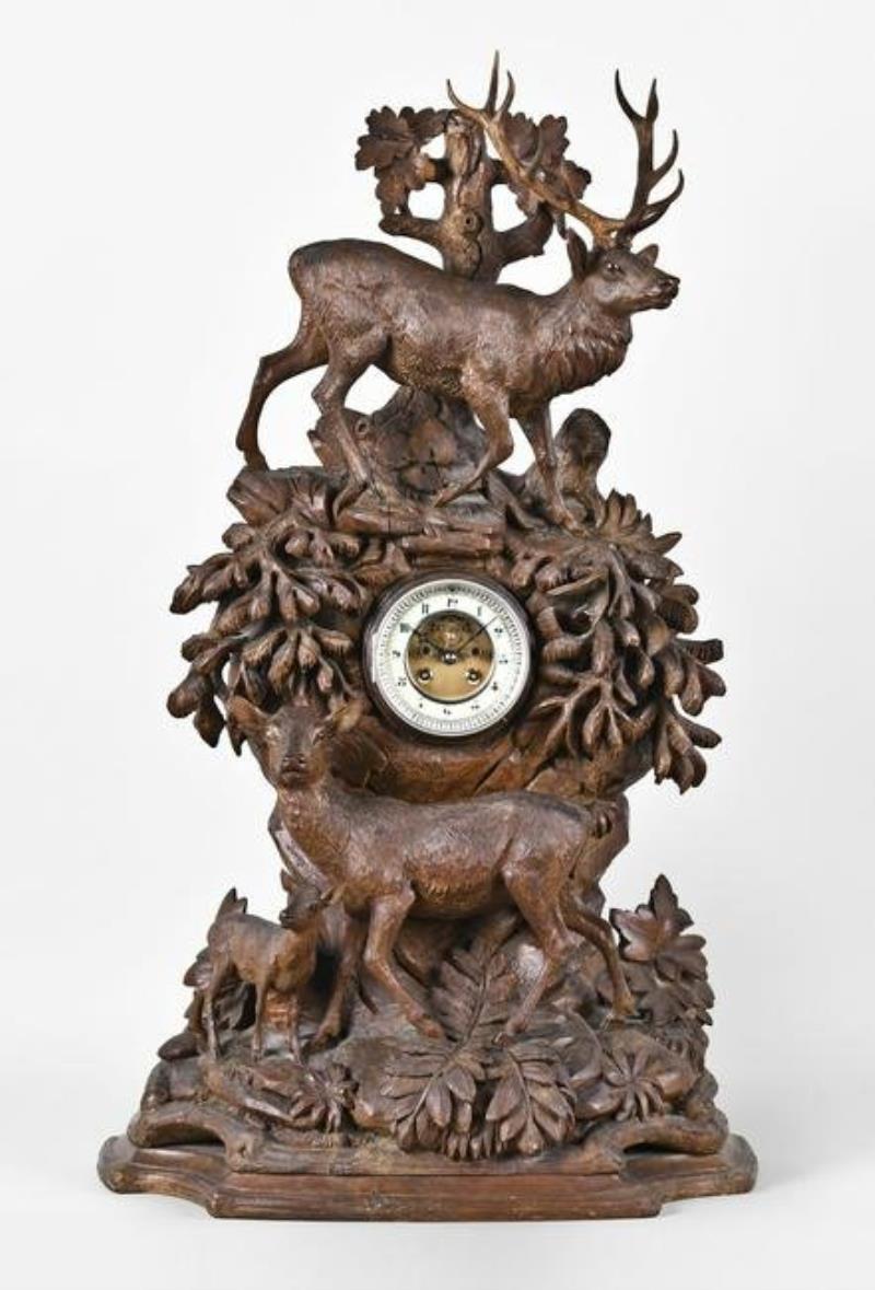 A monumental late 19th century Black Forest carved mantel clock