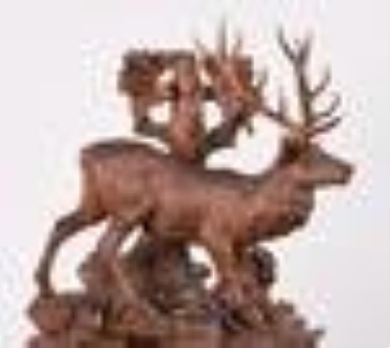 A monumental late 19th century Black Forest carved mantel clock