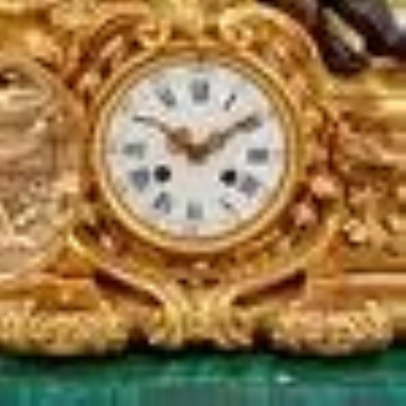 Continental Neoclassical Style Gilt and Patinated Bronze and Malachite Mantel Clock