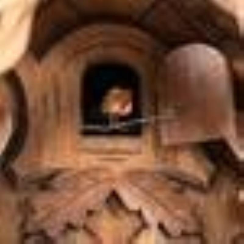 A Black Forest Style Carved Walnut Cuckoo Clock