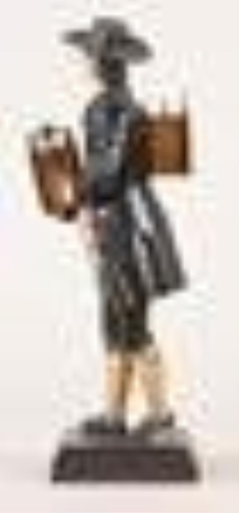 A good mid 19th century Black Forest sheet iron Uhrentrager or clock peddler figure