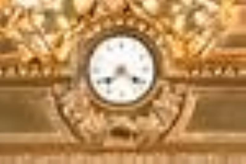 A monumental gilt bronze figural mantel clock in the Louis XVI style signed Robin Her du Roi