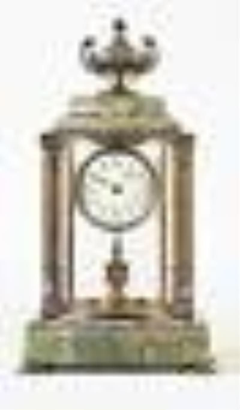 A decorative early 20th century 400 day mantel clock with champleve enamel ornament