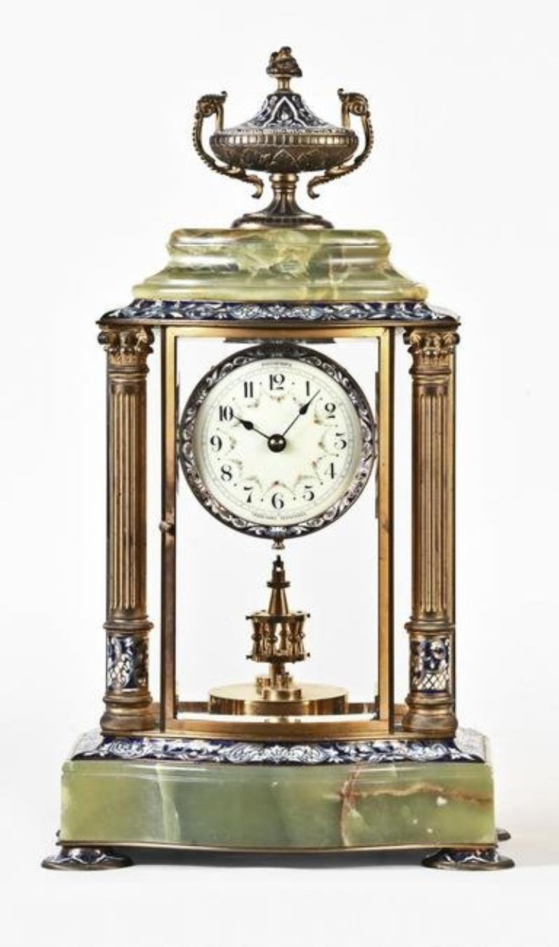 A decorative early 20th century 400 day mantel clock with champleve enamel ornament