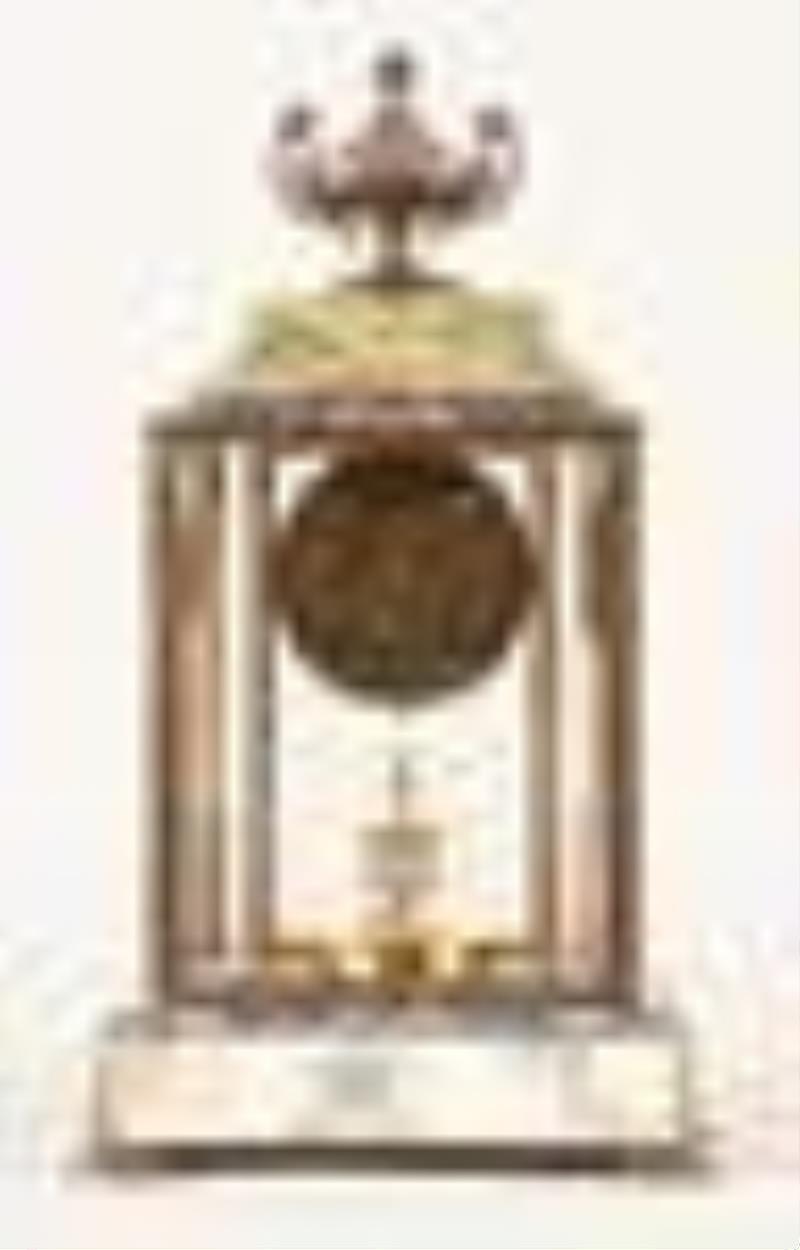 A decorative early 20th century 400 day mantel clock with champleve enamel ornament