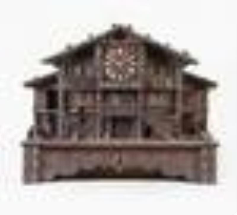 A good late 19th century Swiss carved chalet form clock with music box