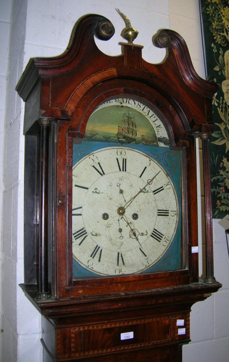 AN OAK AND MAHOGANY LONGCASE CLOCK