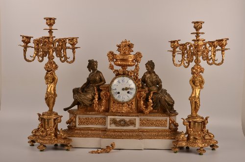 Three piece French gilt bronze and marble figural clock