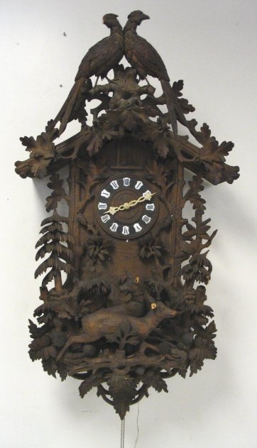 LARGE ELABORATELY CARVED ANTIQUE WALNUT CUCKOO CLOCK