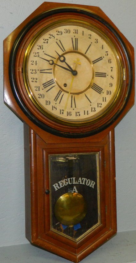 Ansonia regulator calendar clock. 32″ tall.